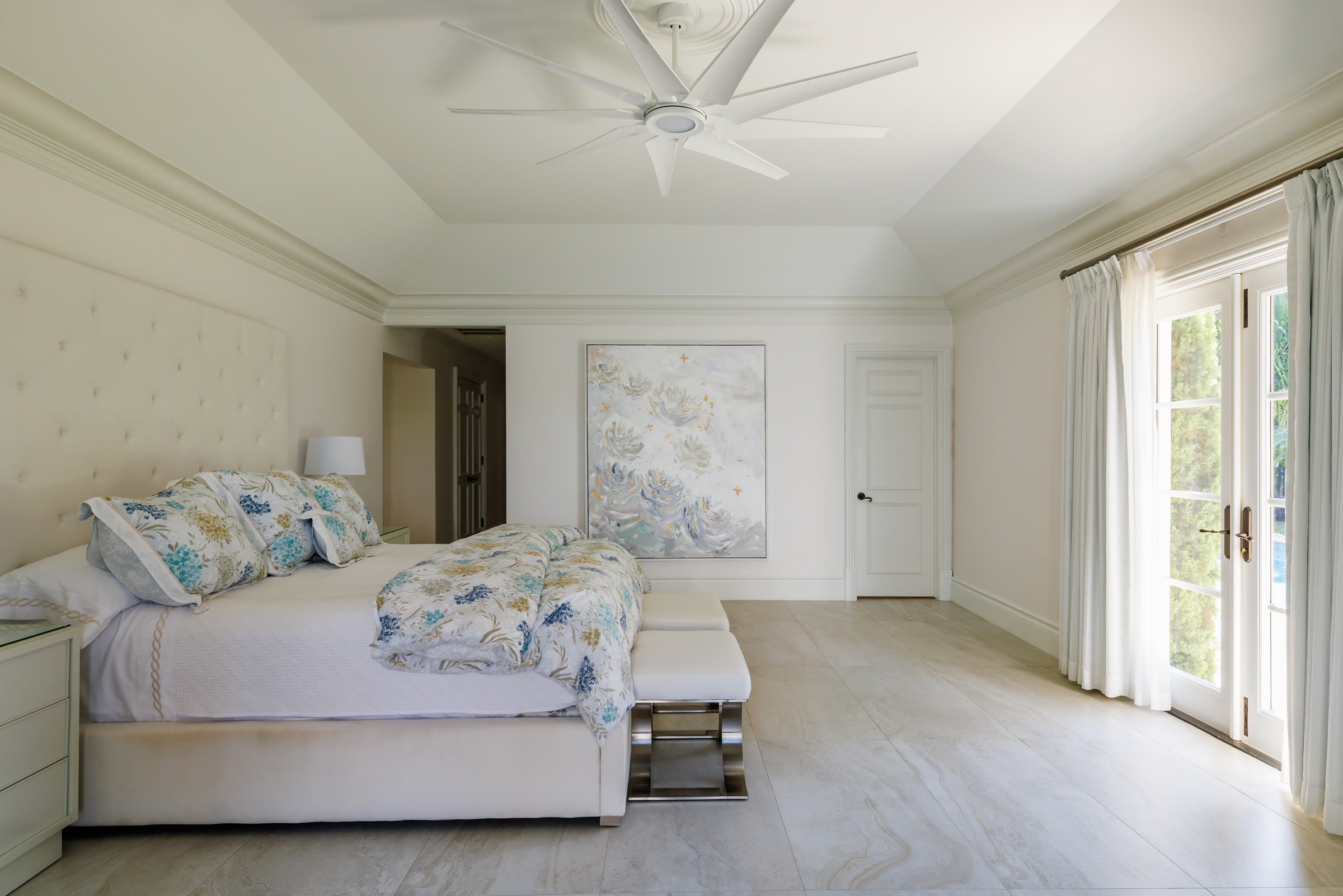 A Carol Calicchio painting installed above a bed in a collector's home